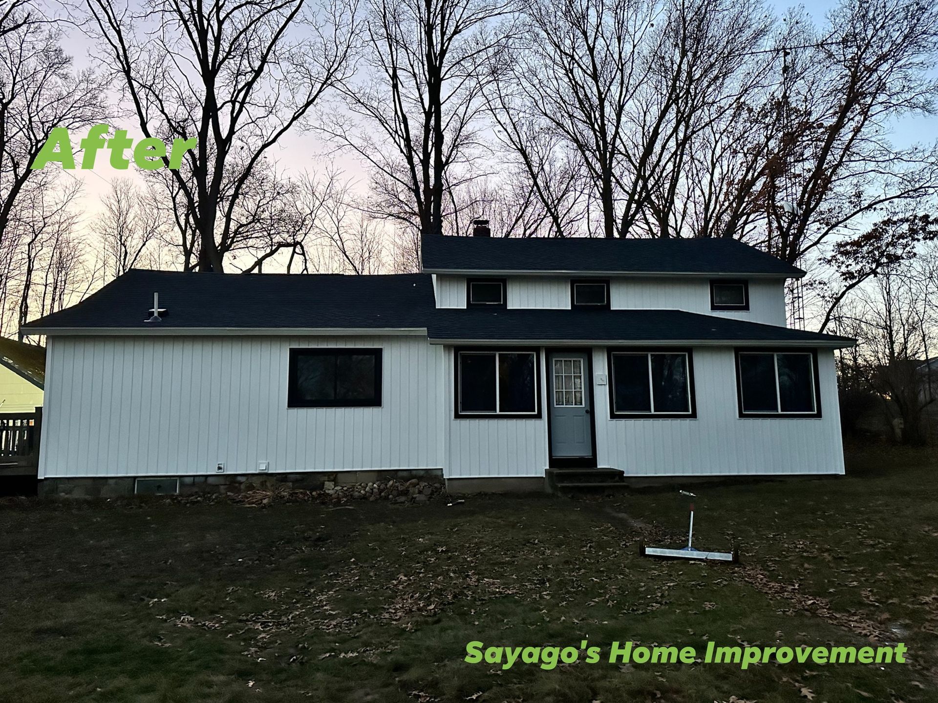 White house with black trim, new roof, and 