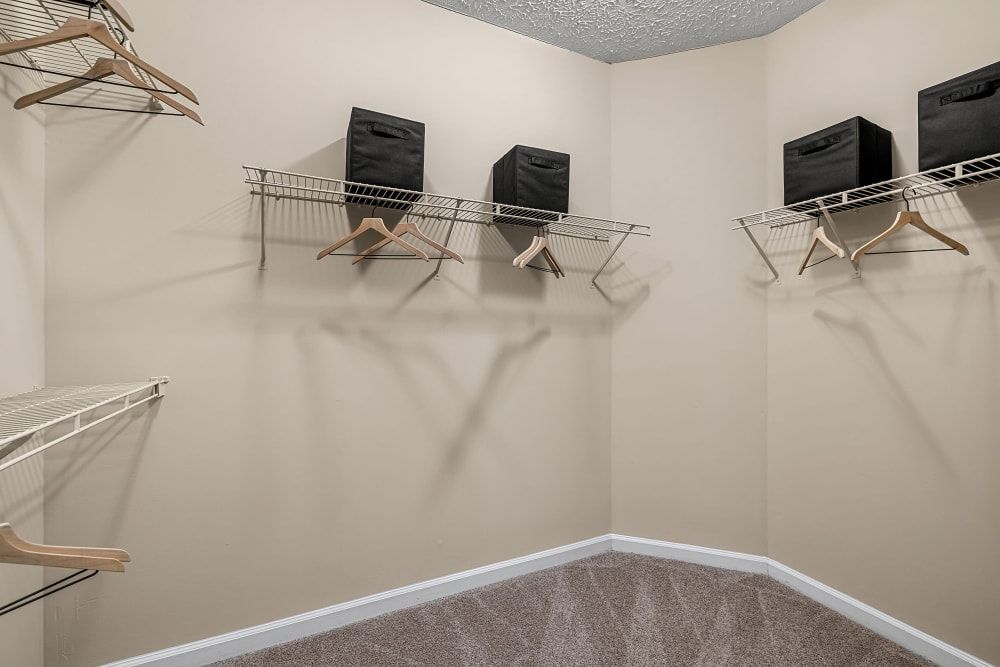 A walk-in closet with a lot of shelves and hangers at Marquis at Sugarloaf in Duluth, GA.