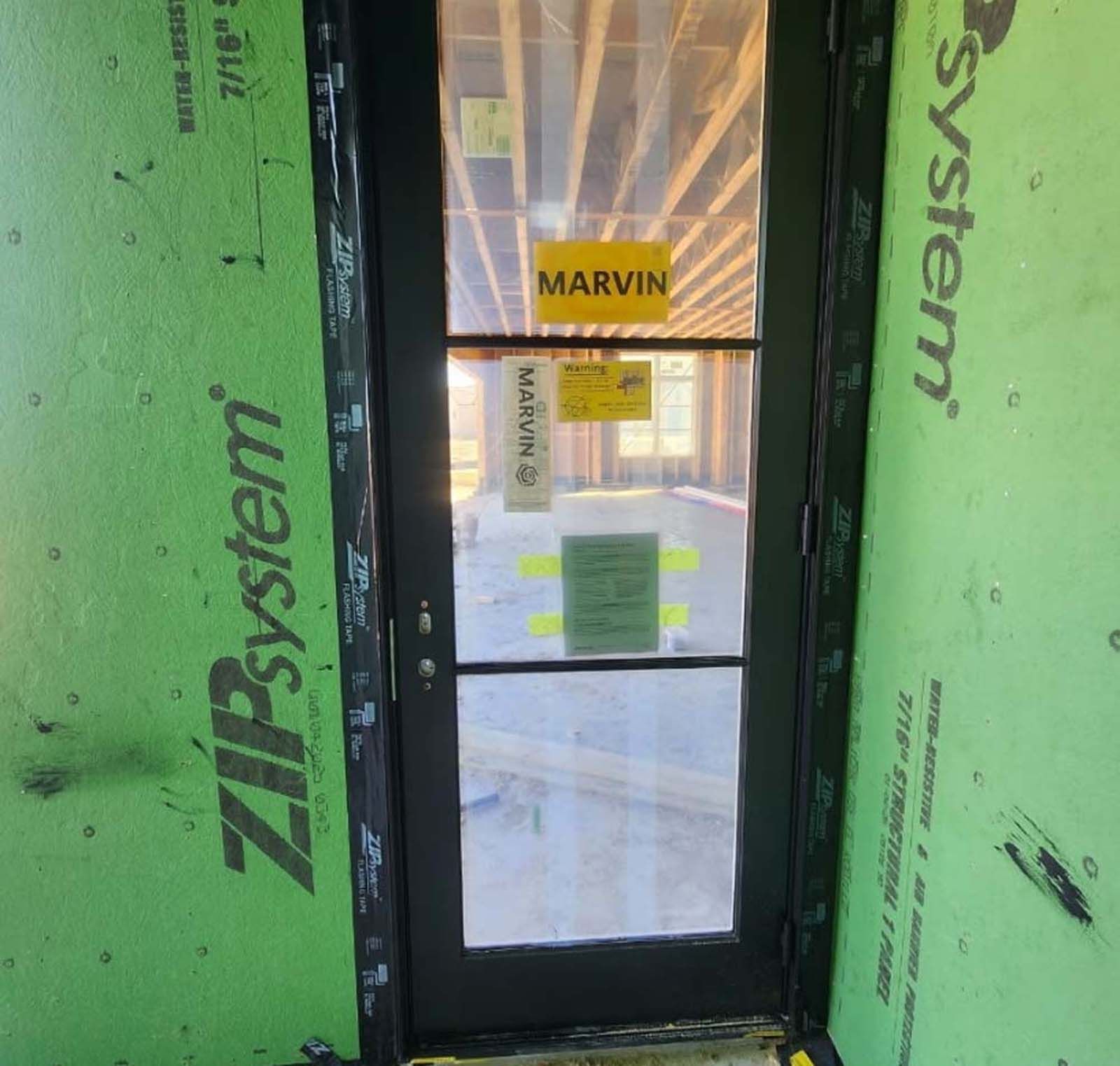 Black door with glass panes, labeled 