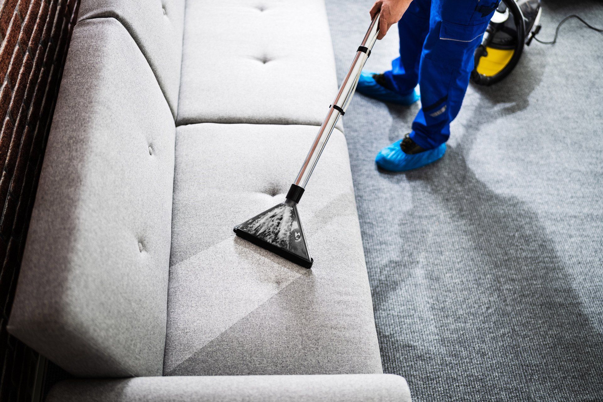 Janitor Cleaning Carpet With Vacuum Cleaning