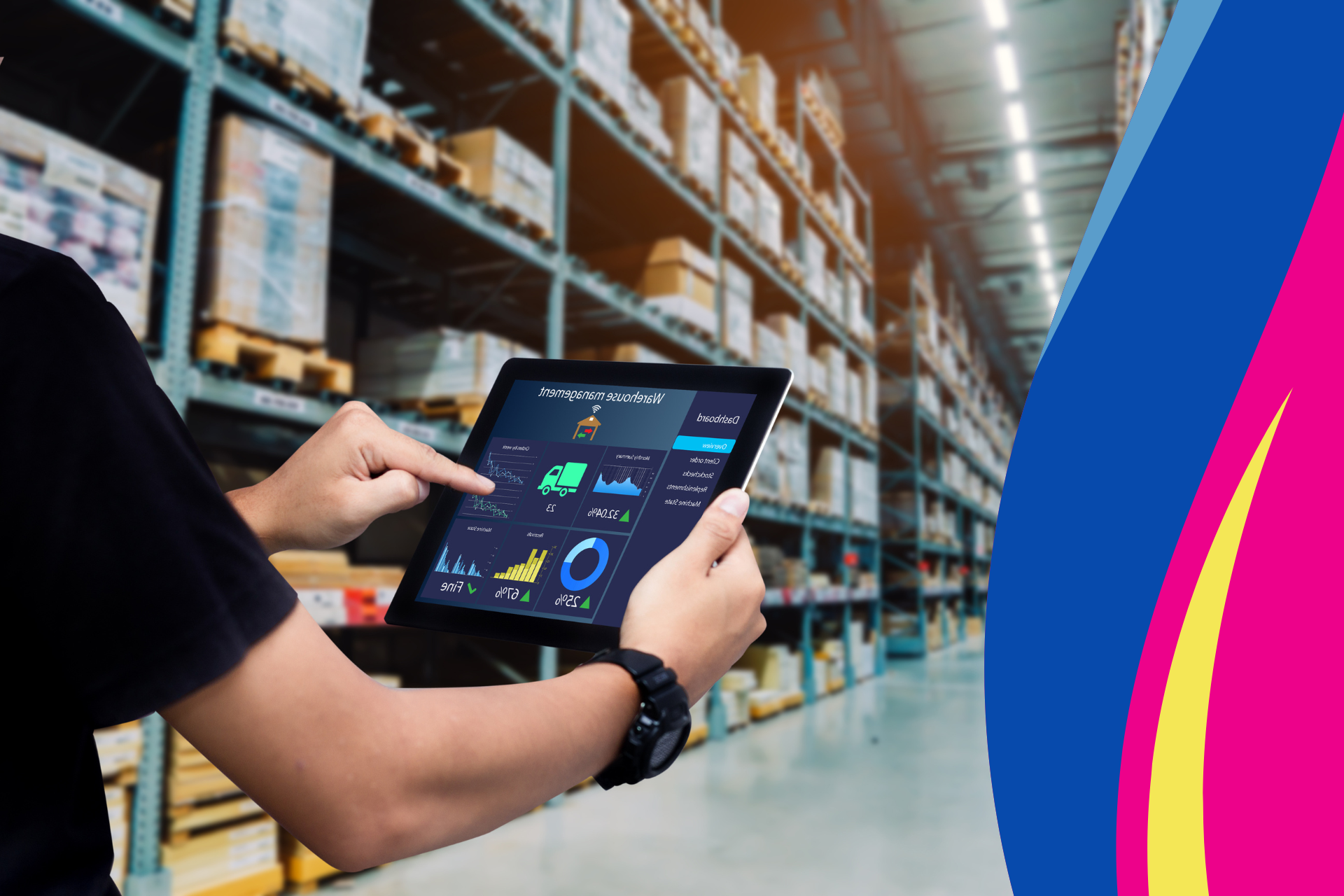 A man is using a tablet in a warehouse.