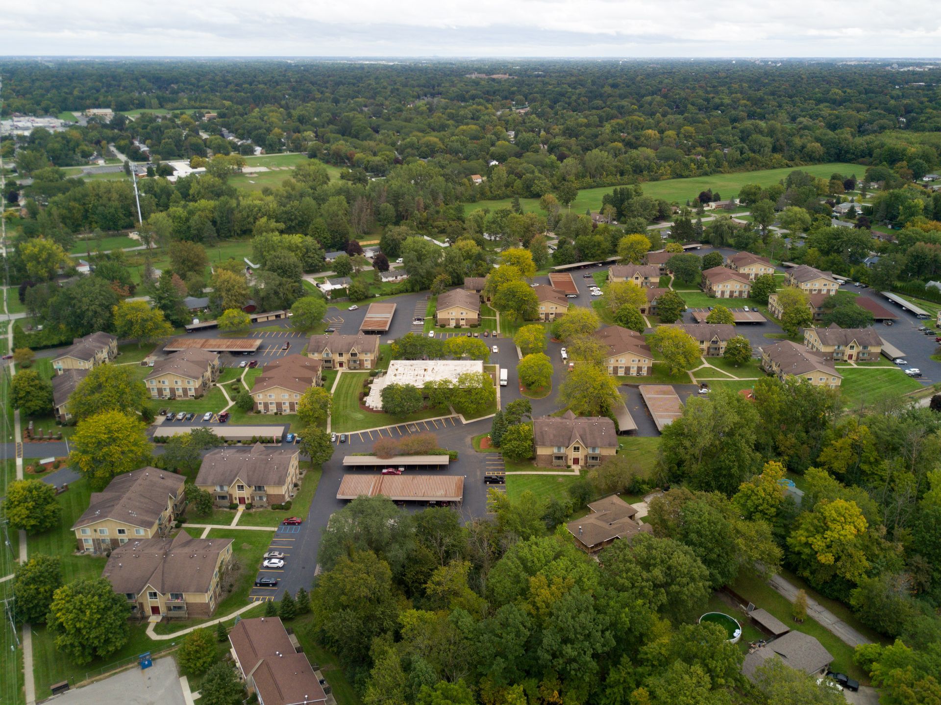 An aerial view of a residential area with lots of trees and houses.