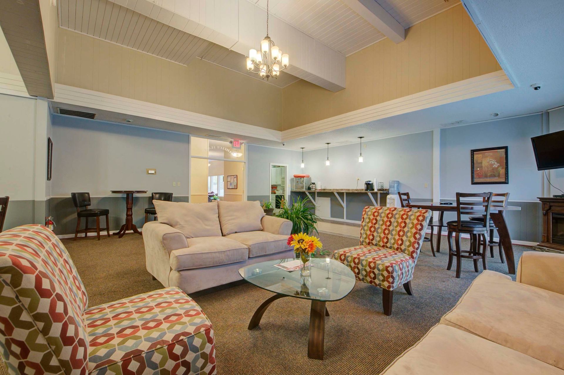 a living room with a couch , chairs , and a coffee table at Camelot Place.