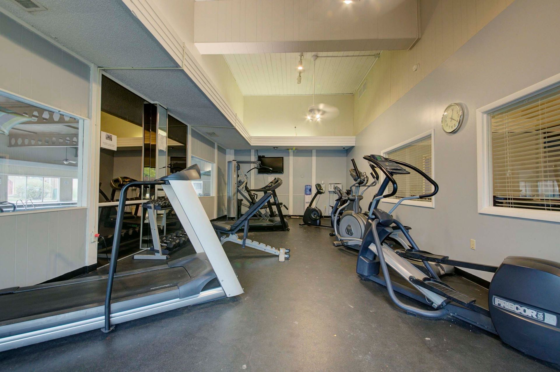 a gym with treadmills , ellipticals , and other exercise equipment at Camelot Place.