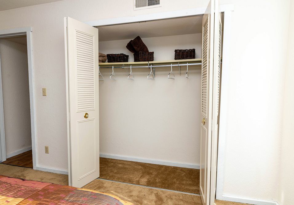a bedroom with a large closet and a bed at Camelot Place.