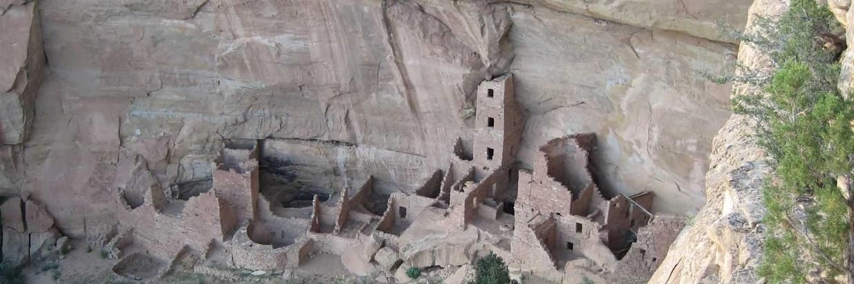 A cliff with a few buildings carved into it