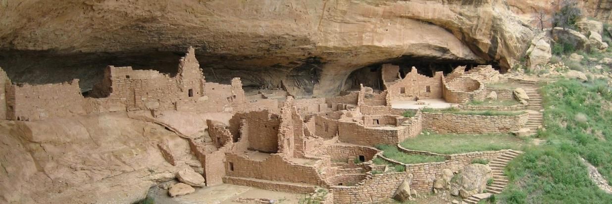 A castle is built into the side of a mountain.