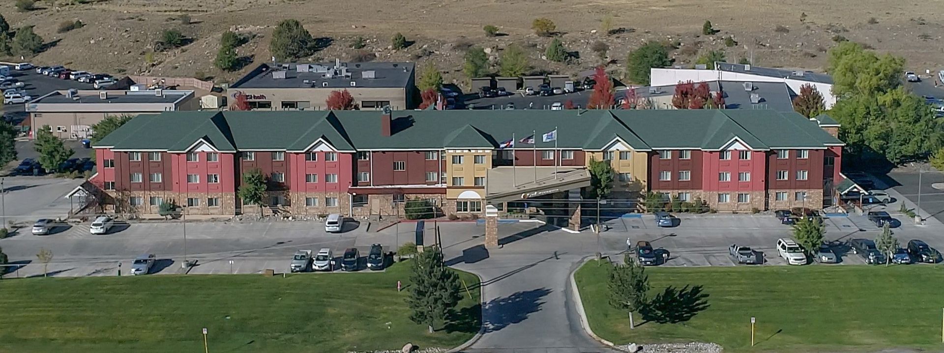 An aerial view of a large building with green roofs
