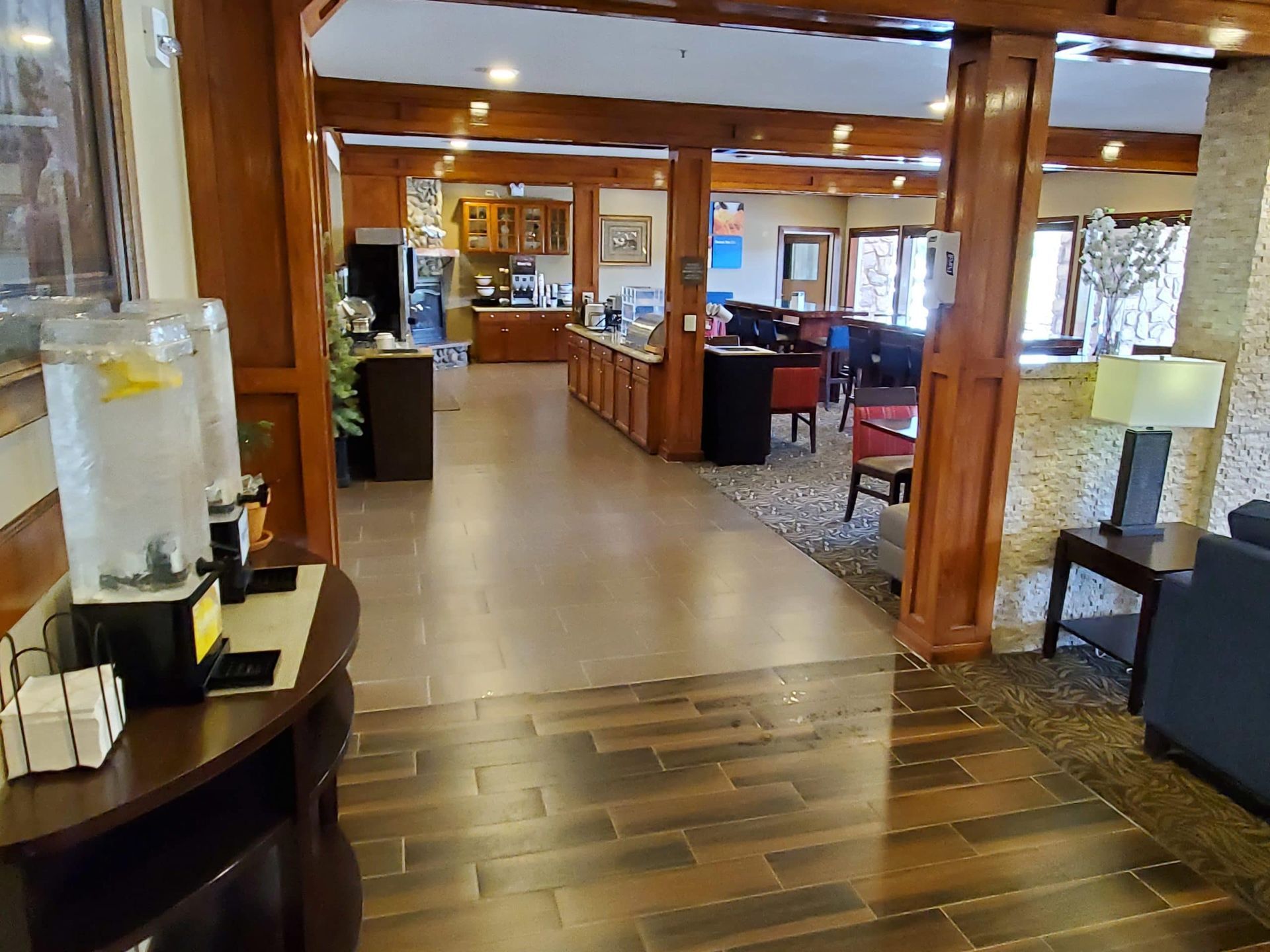 A hotel lobby with a table and chairs in it