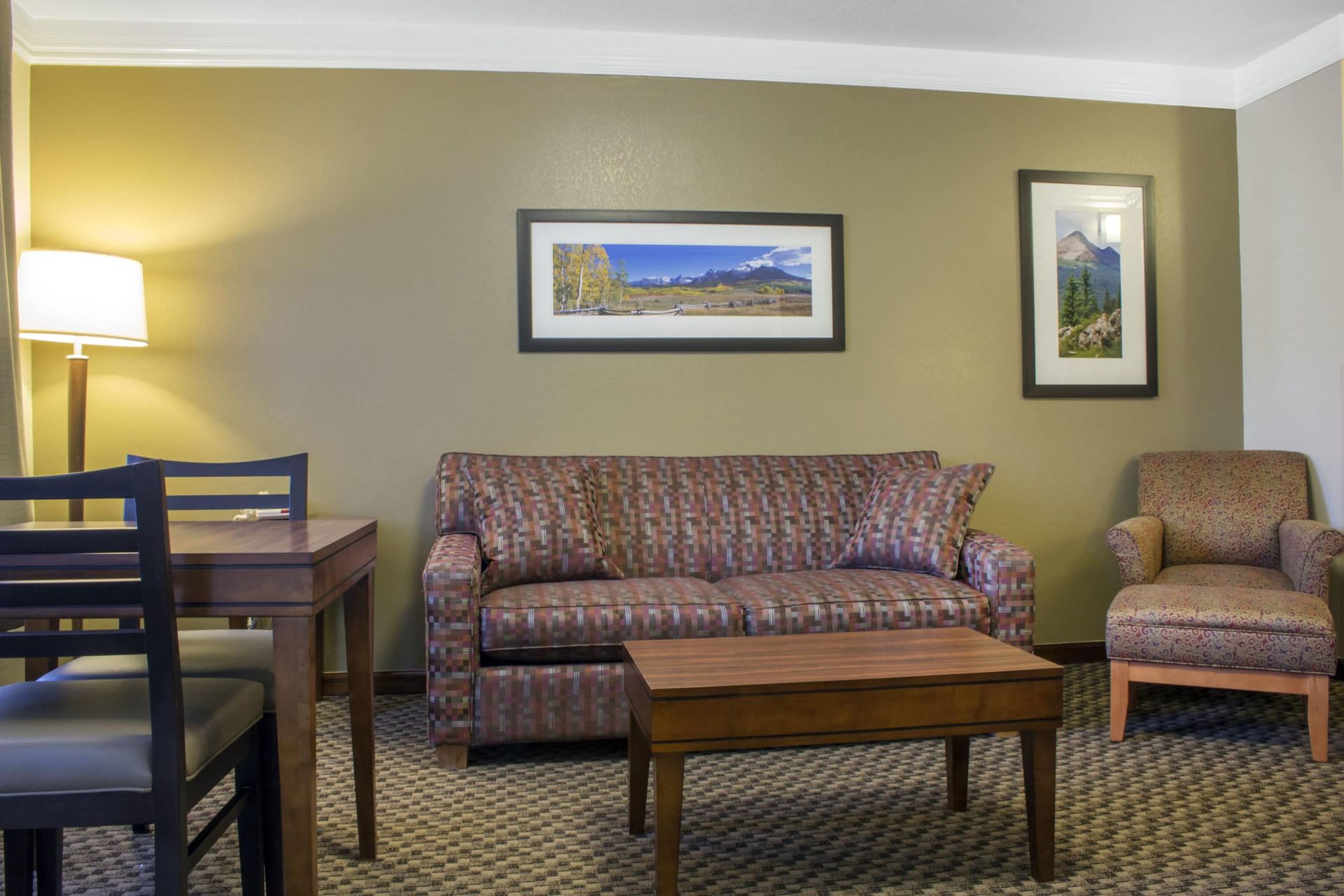 A living room with a couch , chair , table and coffee table.