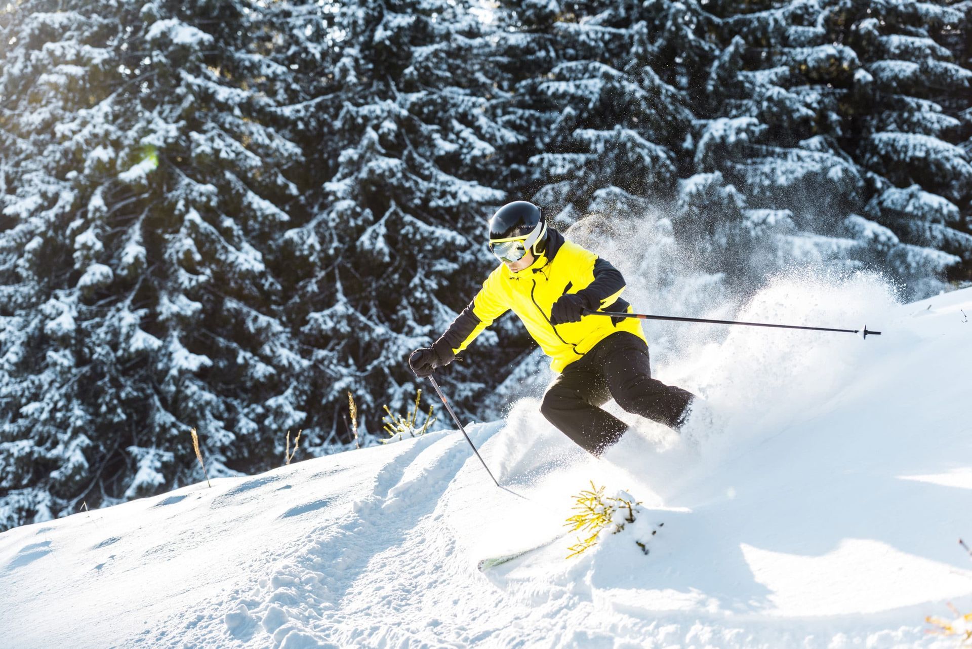 A person is skiing down a snow covered slope.