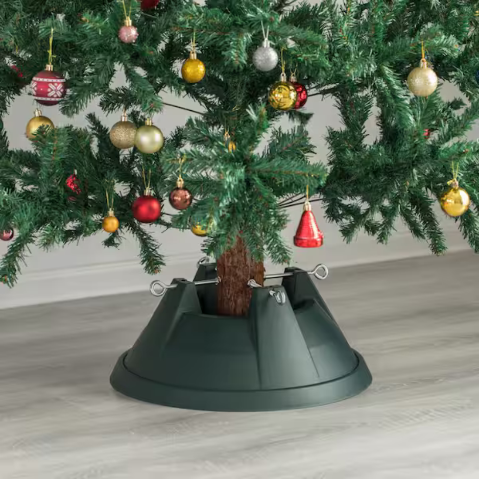 A christmas tree with decorations and a stand underneath it