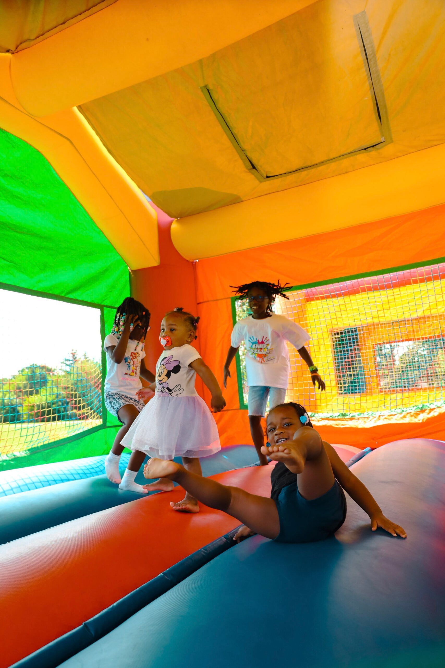 A group of children are playing in a bouncy house.