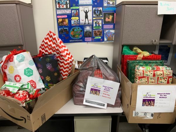 Several boxes filled with christmas presents are sitting on a table.