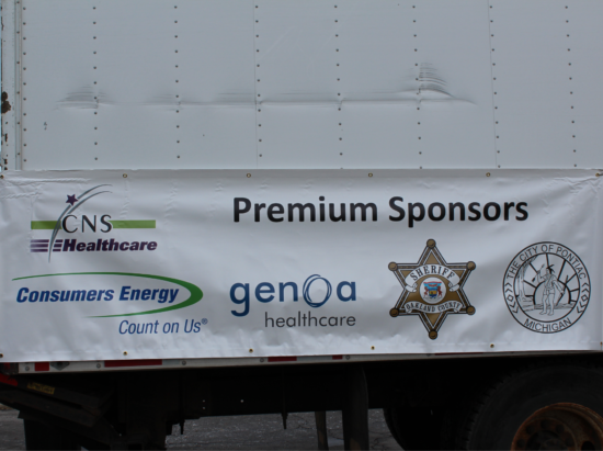 A white trailer with a banner that says premium sponsors