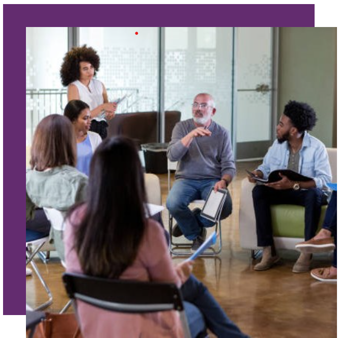 A group of people are sitting in a circle in a room.