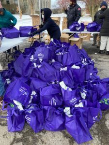 A pile of purple bags sitting on top of a table.