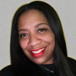 A woman with long black hair and red lipstick is smiling for the camera.