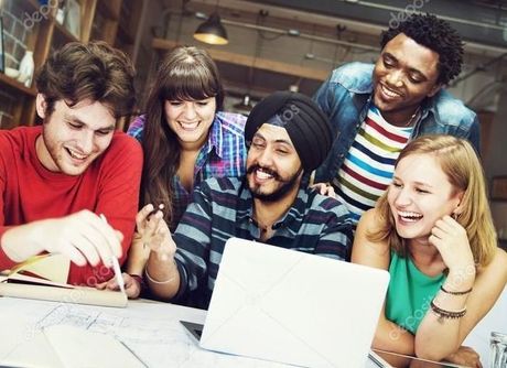 A group of young people are looking at a laptop computer.