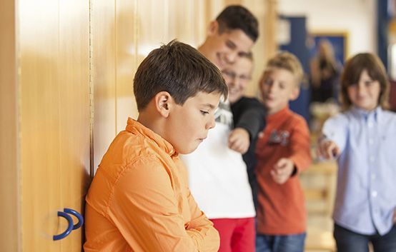 kids bullying in a hall