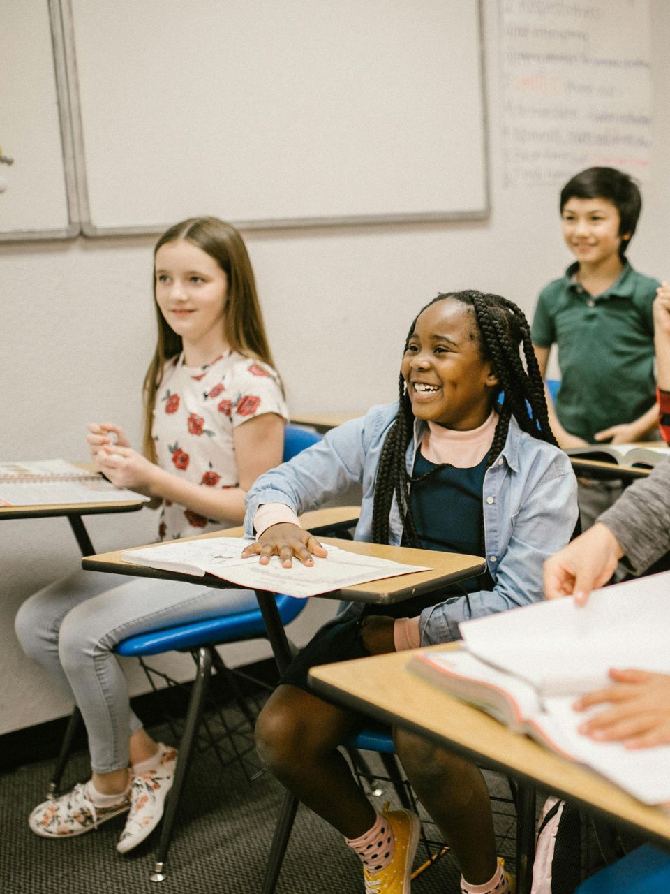 A group of children are sitting at desks in a classroom.