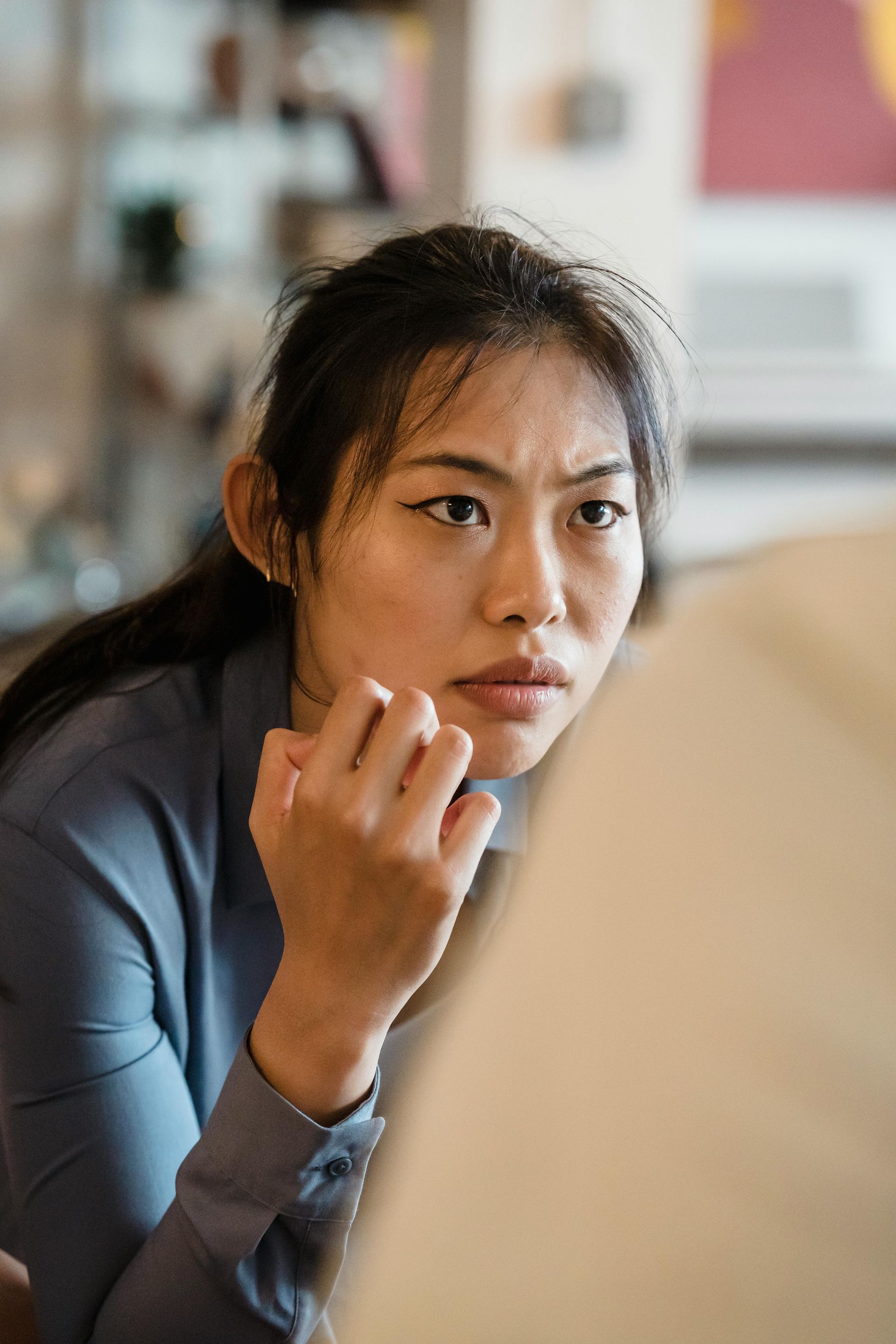 A woman is sitting in front of a laptop computer.