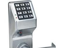 A close up of a keypad on a door lock on a white background.