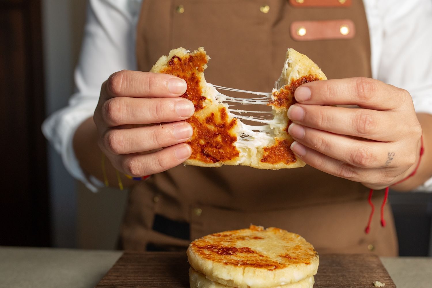 A person is holding a piece of food in their hands.