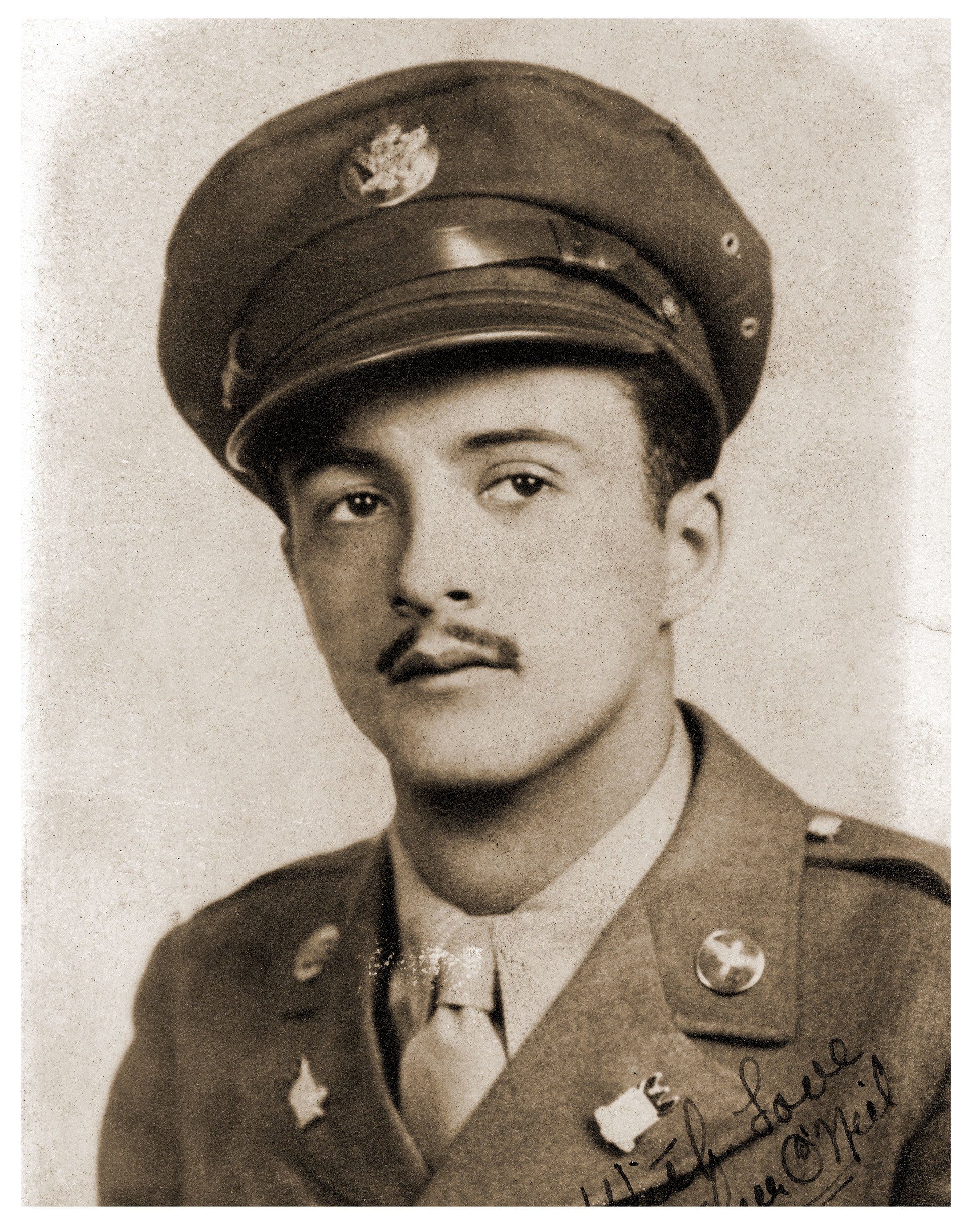 Sepia-toned portrait of a young man in a military uniform with a mustache and cap.