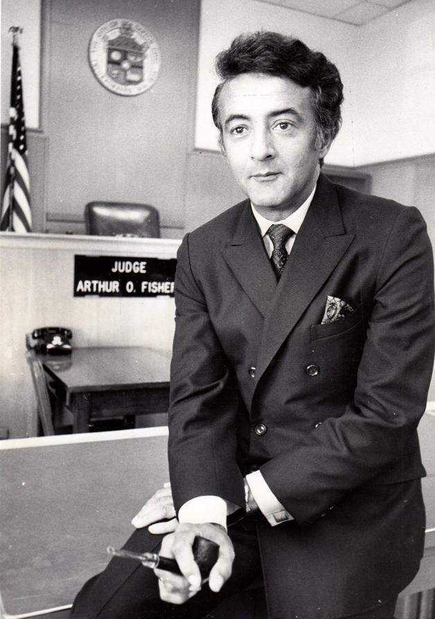 Judge Arthur D. Fisher in courtroom. He's in a suit, sitting on a bench, looking at the camera.