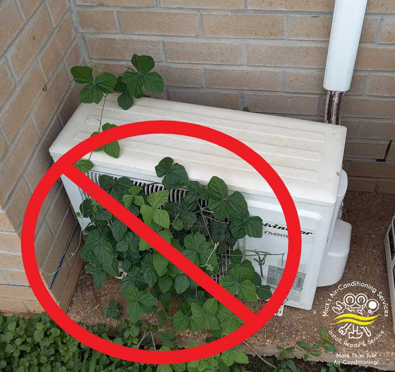 Weeds Growing Around A Kelvinator Inverter — Mick’s Air-Conditioning Services in Gracemere, QLD