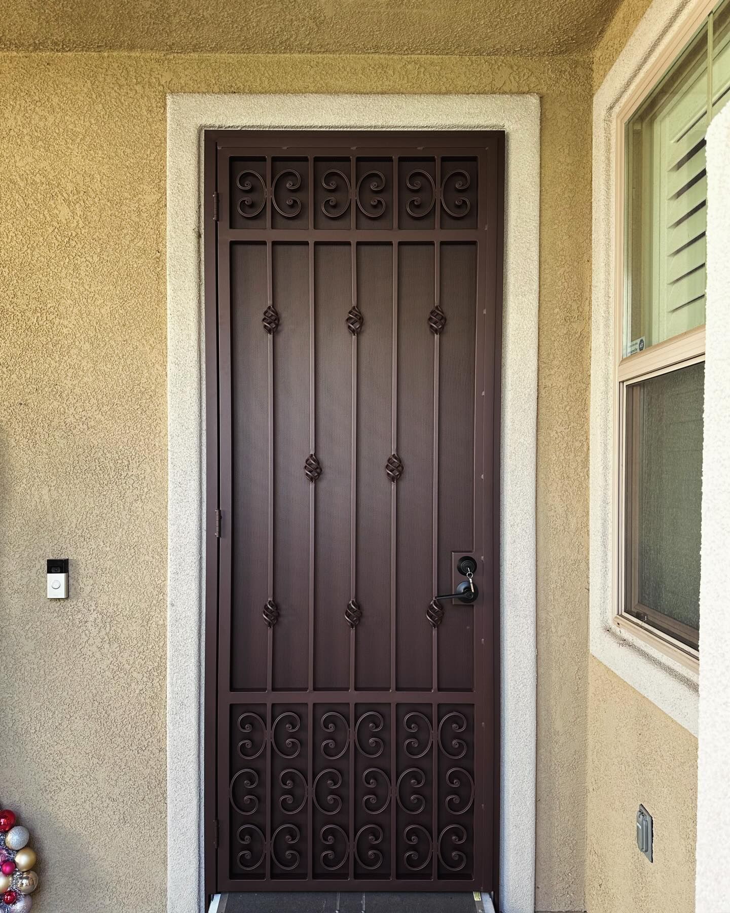 A brown door with a wrought iron design on it