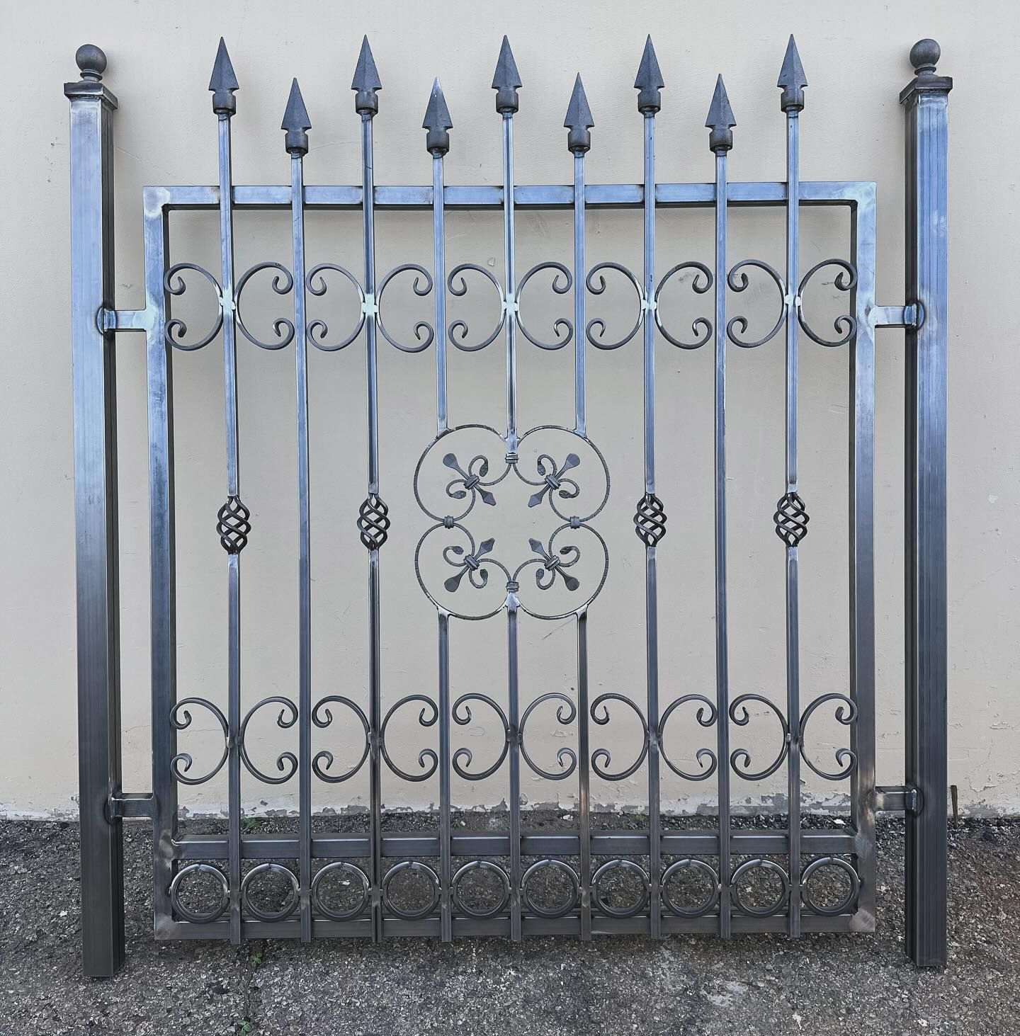 A wrought iron gate with a fancy design on it