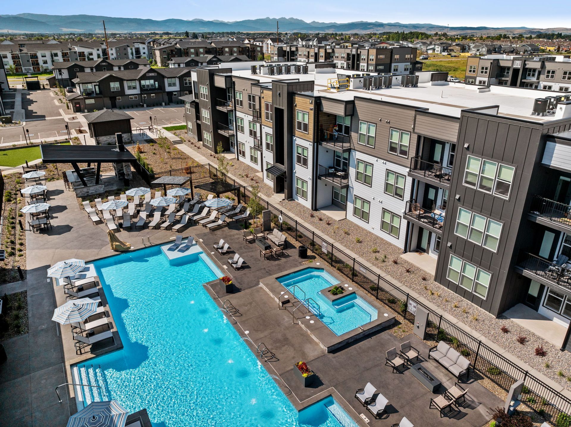 Outdoor seating area with a fire pit, Adirondack chairs, and mountain views.