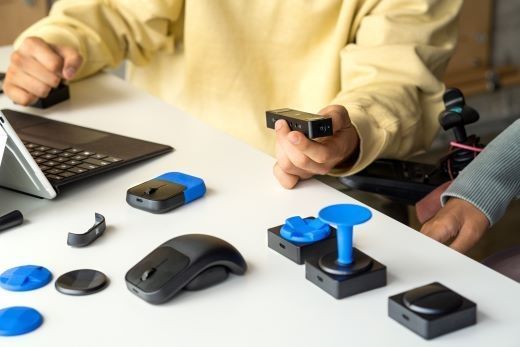 A collection of brightly colored 3D printed joysticks and button shapes