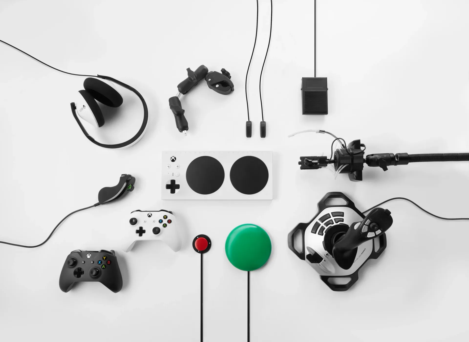 Xbox Adaptive Controller with additional game controllers, switches, and joysticks around it