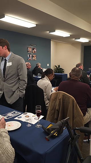 A group of people are sitting at tables in a room.