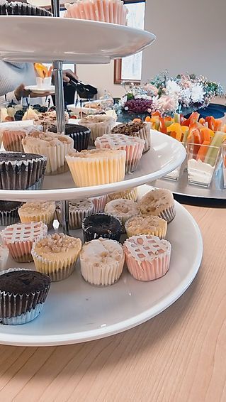 A tray of cupcakes is sitting on top of a wooden table.