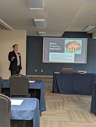 A man is giving a presentation in front of a large screen.