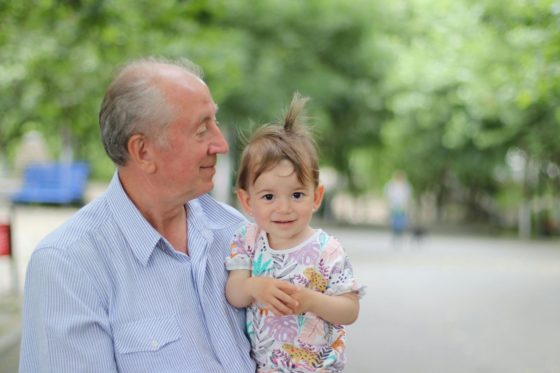 A man is holding a little girl in his arms.