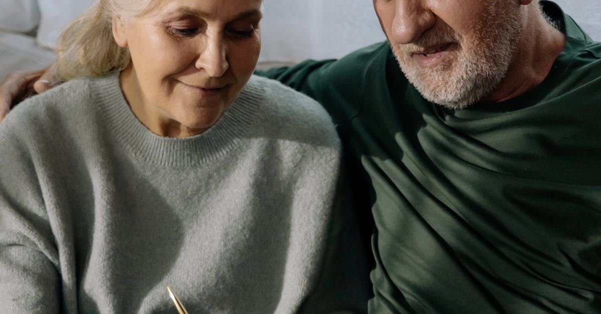 A man and a woman are sitting next to each other on a couch.