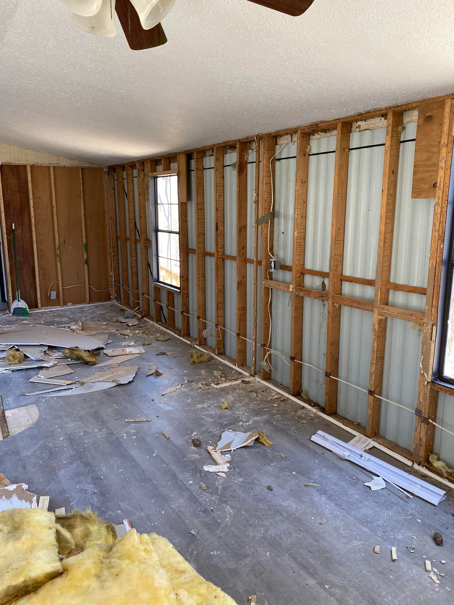 A room with a lot of wooden walls and a ceiling fan.