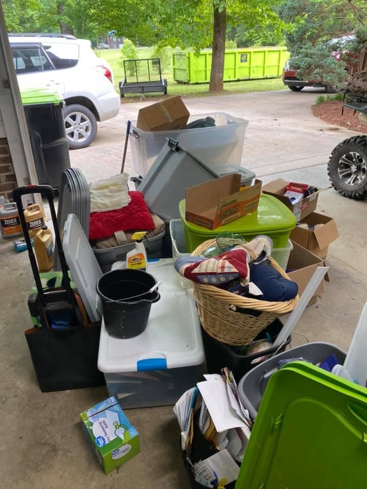 A pile of boxes and baskets in a garage.
