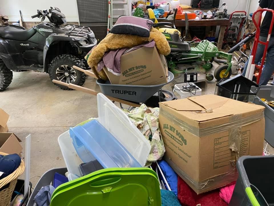 A garage filled with lots of boxes and a atv.