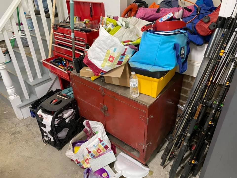 A bunch of fishing rods are sitting on top of a red dresser.
