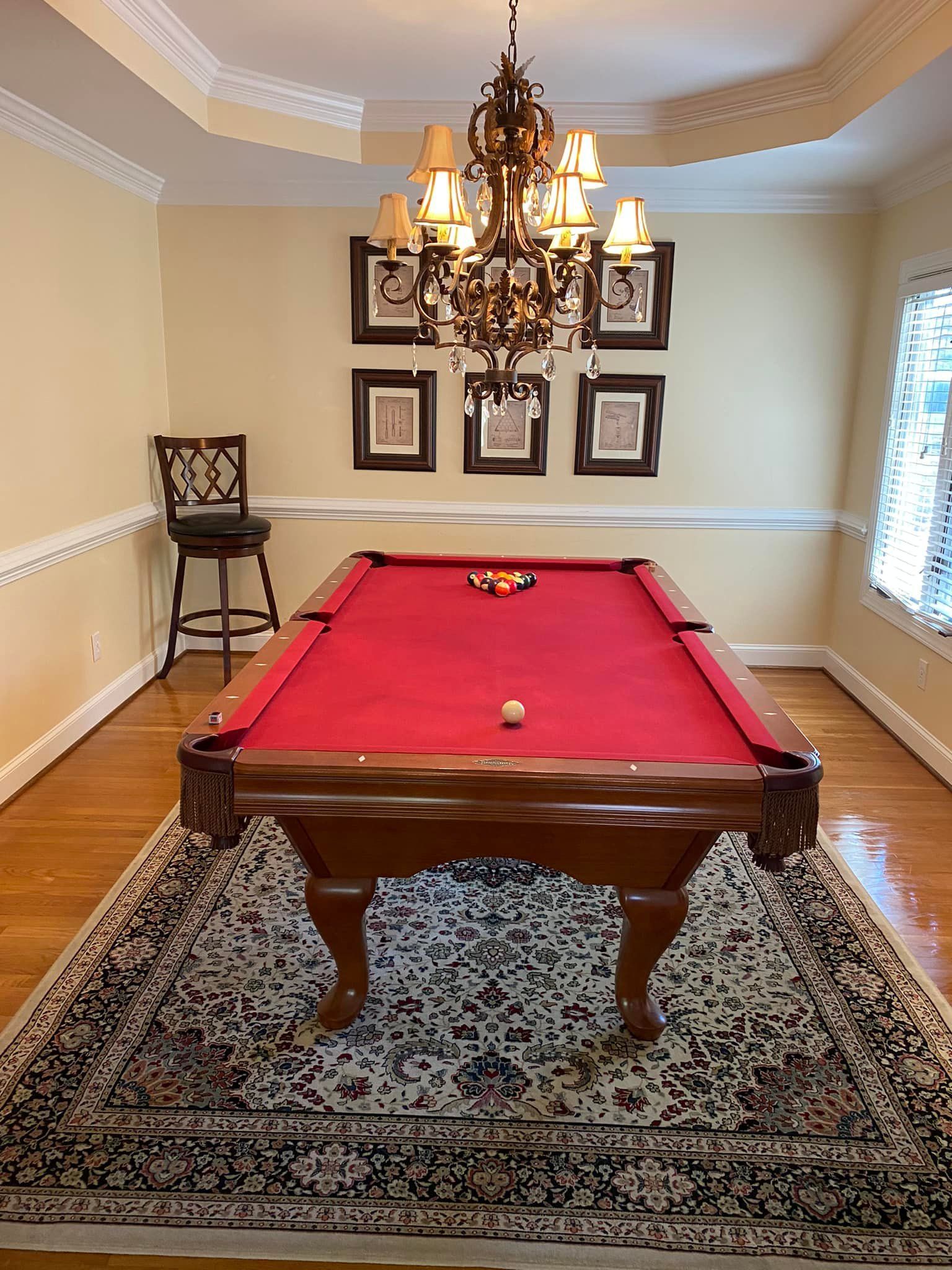 There is a pool table in the middle of the room.