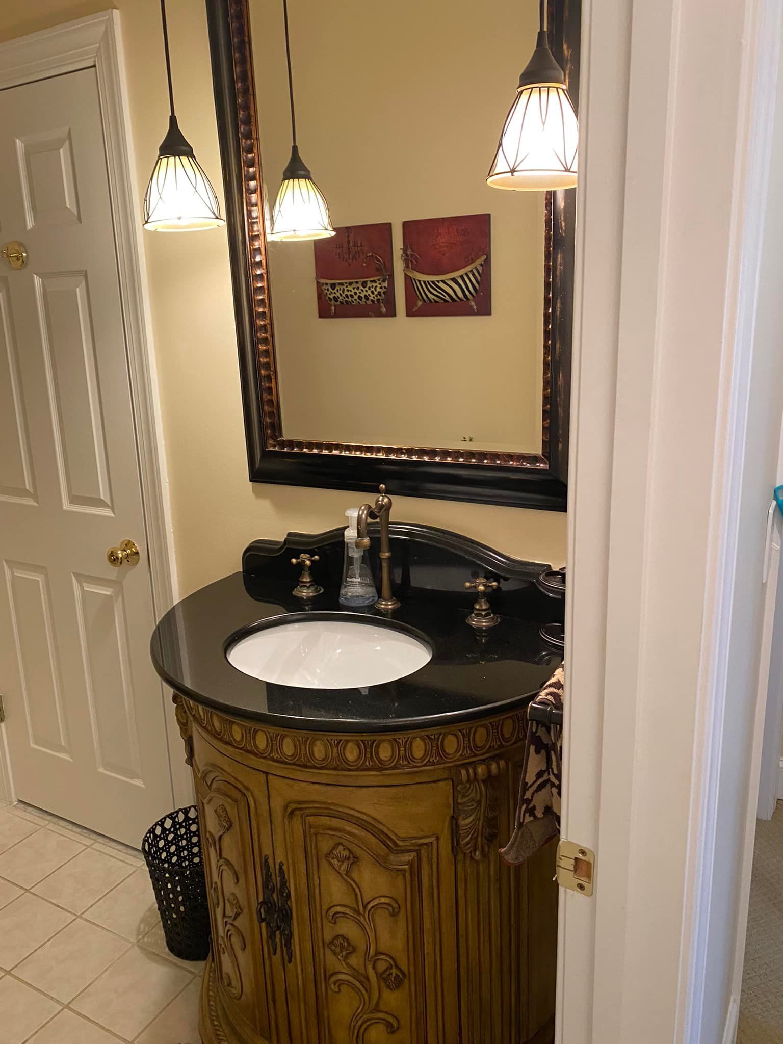 A bathroom with a sink , mirror and cabinet.