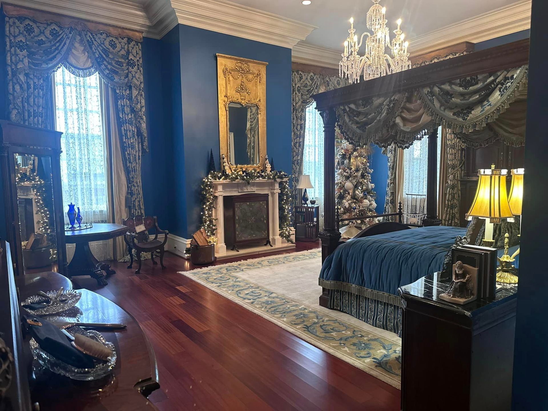 A bedroom with a four poster bed and a fireplace