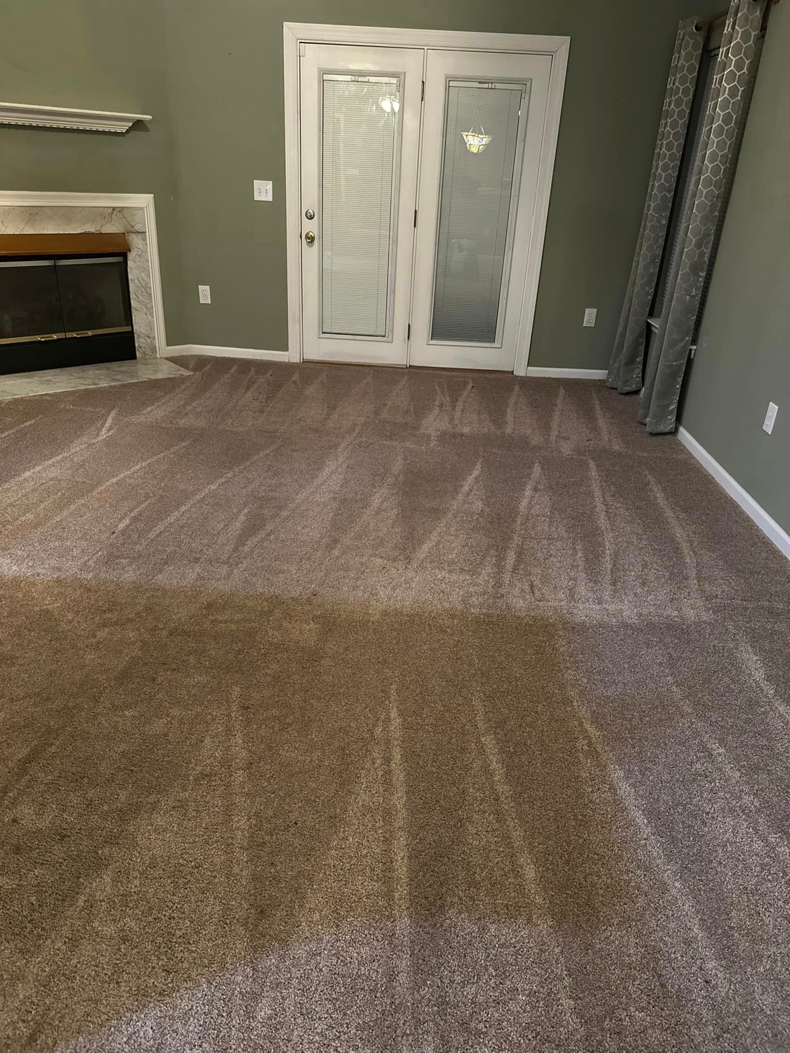 A living room with a fireplace and sliding glass doors.