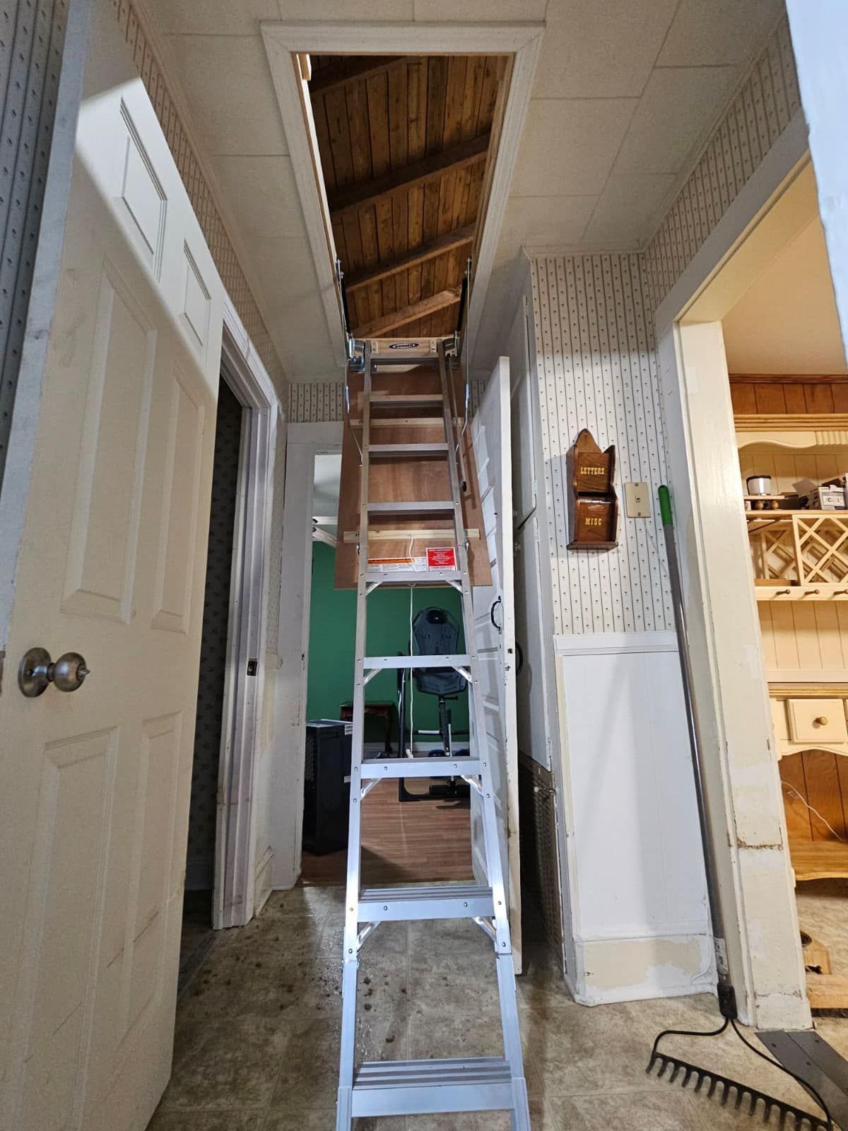 A ladder is leading up to a loft in a house.